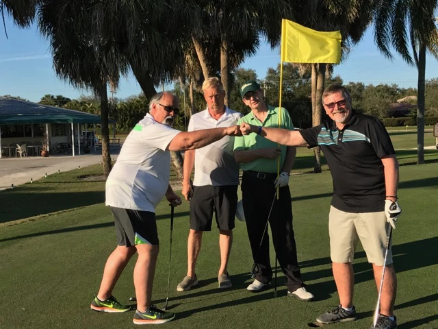 picture of four golfers finishing a round.